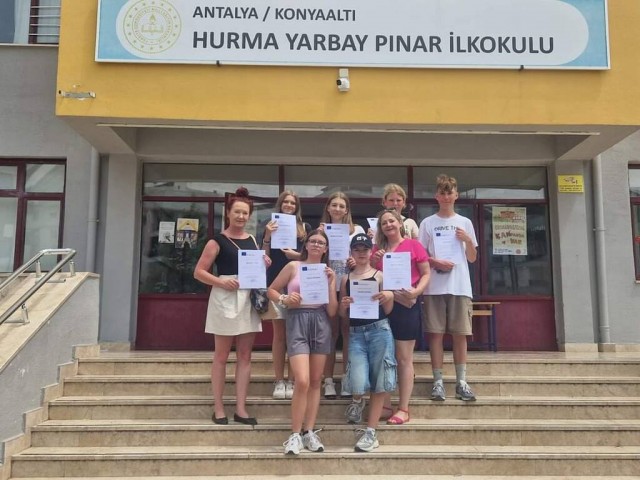 Kadr przedstawia grupę uczestników wyjazdu do Turcji trzymających certyfikaty uczestnictwa